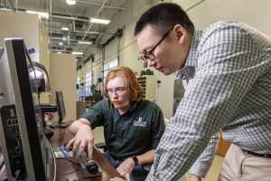 BATT CAVE director Jun Xu with student