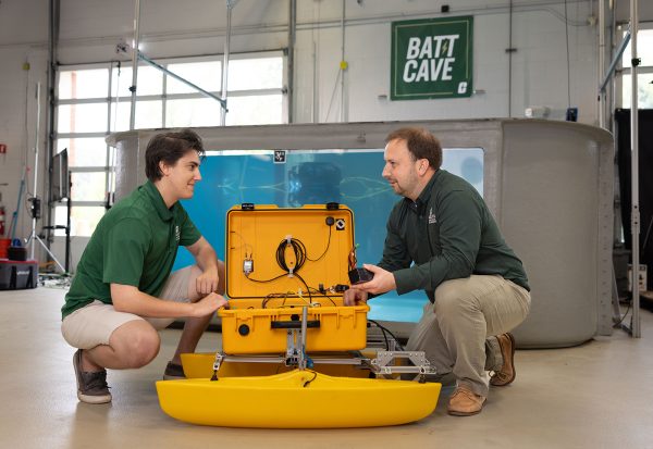 Artur Wolek works on marine robotics with student in BATT CAVE