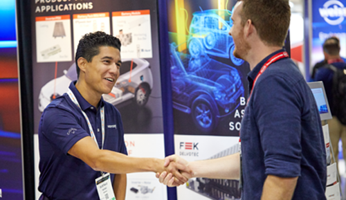 Two men at a convention shaking hands