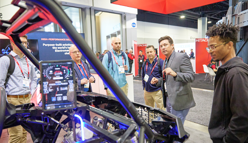 A group of men standing around a machine display